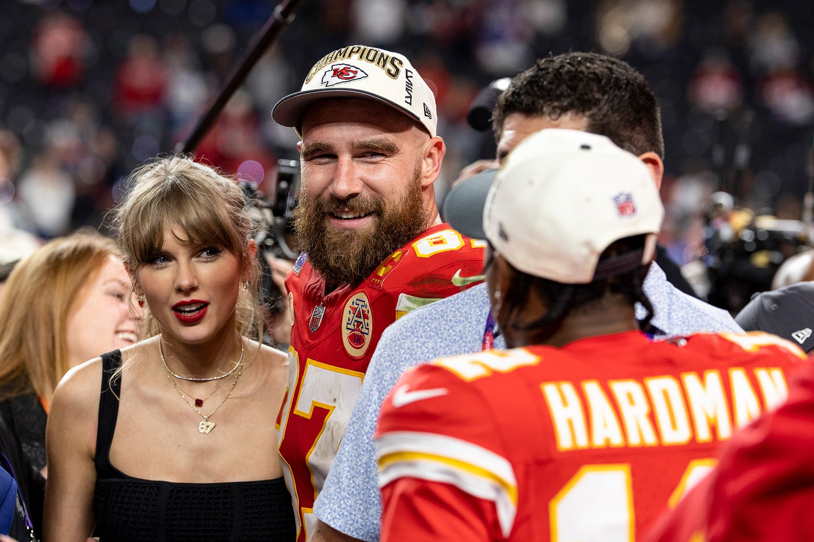 התמונה עשויה להכיל את Travis Kelce Taylor Swift ביגוד כובע אנשים אדם שיחה אביזרים ותכשיטים למבוגרים